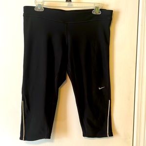 Nike running reflective black capris, size large, lovingly worn.